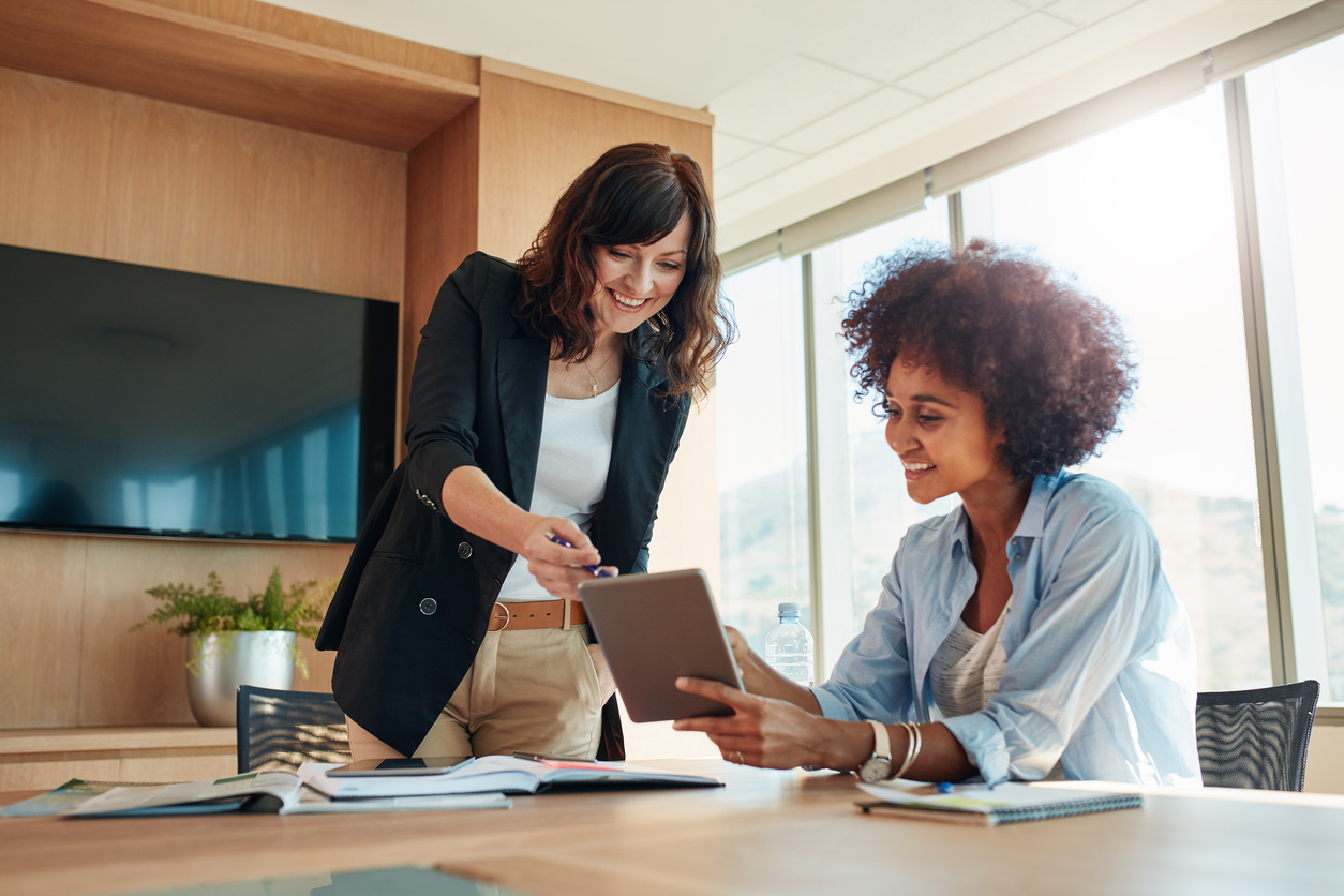 Business partners using touchscreen computer for project discussion